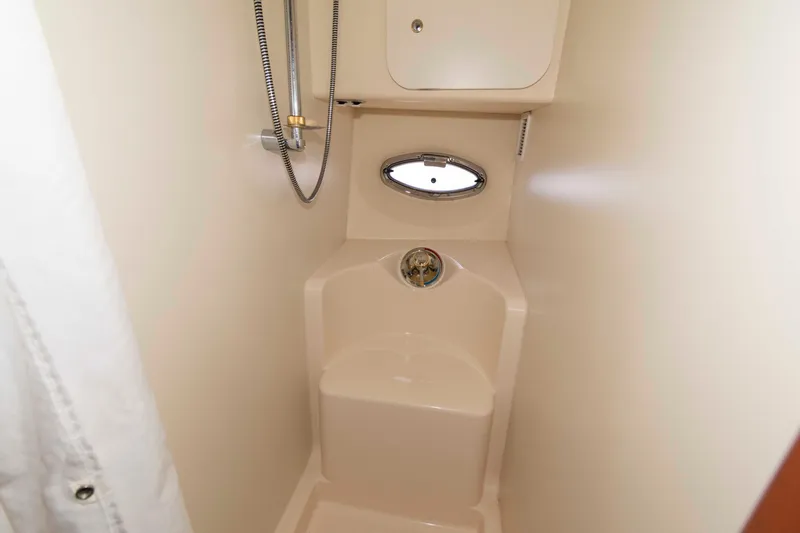 Slide: The Image of 2004 Silverton 34 Convertible yacht bathroom with shower and porthole window. - 23
