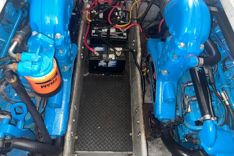 Slide: The Image of Engine compartment of a 2004 Silverton 34 Convertible with blue-painted components and batteries. - 27