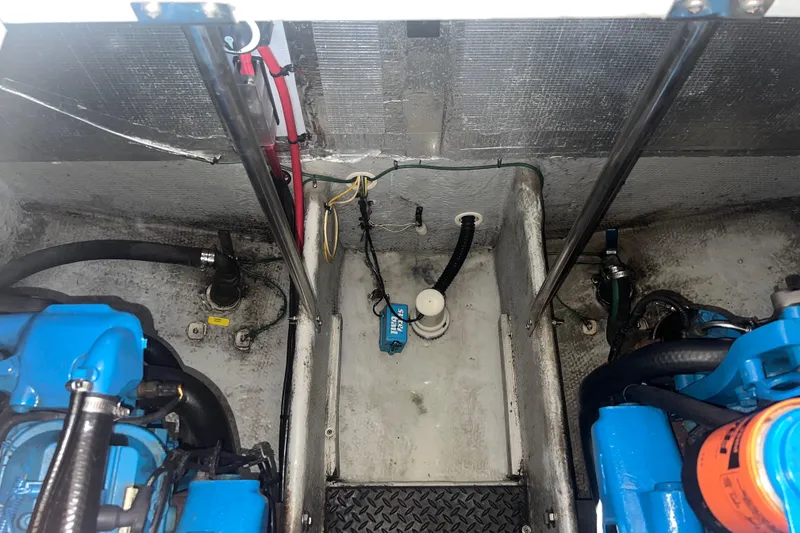 Slide: The Image of Engine compartment of a 2004 Silverton 34 Convertible boat, showing mechanical components. - 28