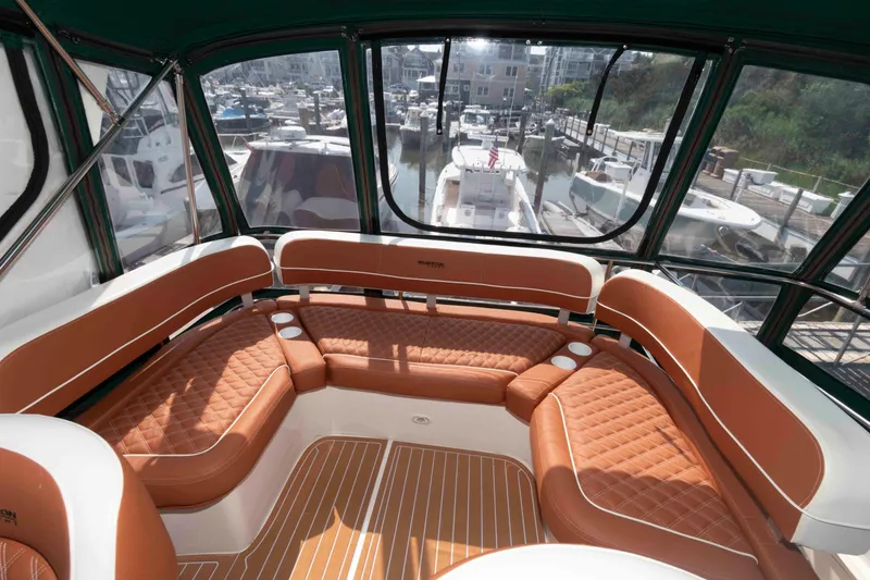 Slide: The Image of Interior of 2004 Silverton 34 Convertible yacht with brown leather seating. - 6