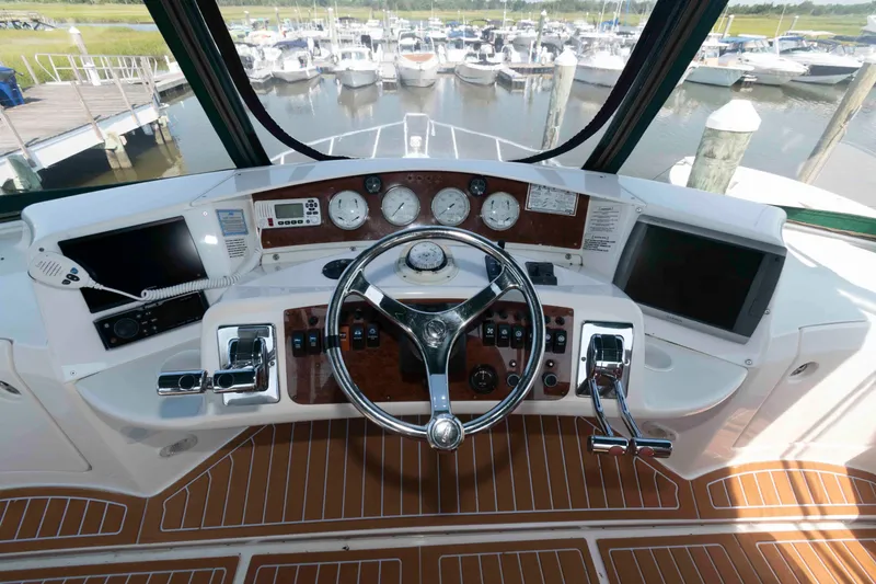 Slide: The Image of Helm of 2004 Silverton 34 Convertible yacht with steering wheel and control panels. - 8