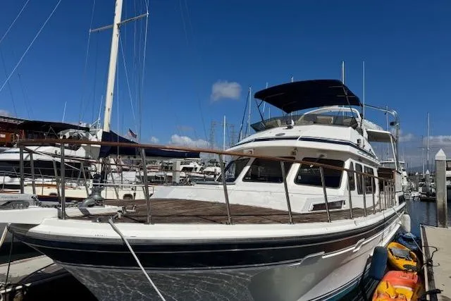 The Image of 1985 Spindrift Trawler docked at marina under clear blue sky. - 0