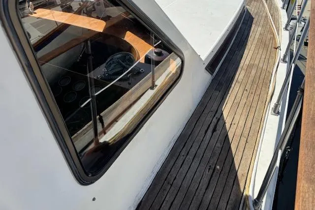 Slide: The Image of 1985 Spindrift Trawler with wooden deck and cabin window view. - 11