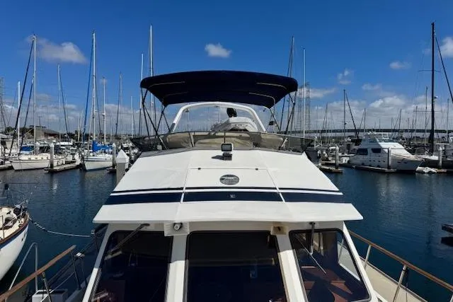 Slide: The Image of 1985 Spindrift Trawler docked in a marina under a clear blue sky. - 15