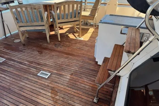 Slide: The Image of 1985 Spindrift Trawler deck with wooden flooring and seating area. - 16