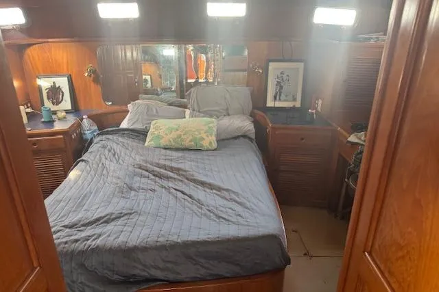 Slide: The Image of Cozy bedroom interior of 1985 Spindrift Trawler with wooden furnishings and soft lighting. - 7