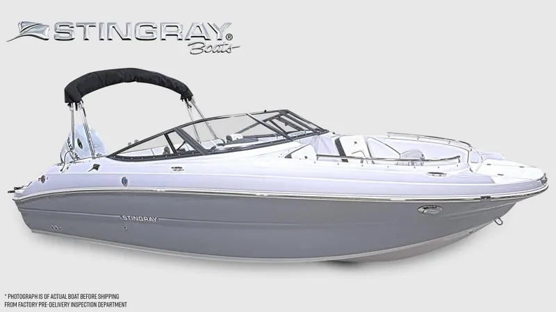 The Image of 2025 Stingray 231 DC boat with sleek design and black canopy. - 0