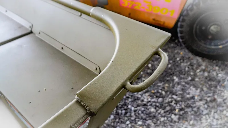 Slide: The Image of 2025 G3 Gator Tough 1448 LW boat detail, showing sturdy metal handle and seating area. - 6