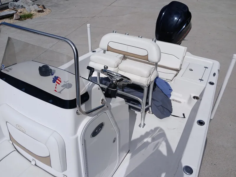 Slide: The Image of 2015 Sportsman Tournament 234 Bay Boat with seating and console, parked on concrete. - 11