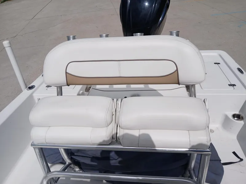 Slide: The Image of 2015 Sportsman Tournament 234 Bay Boat seating with white cushions and stainless steel frame. - 3