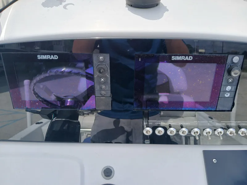 Slide: The Image of 2015 Sportsman Tournament 234 Bay Boat dashboard with dual Simrad displays and control switches. - 6