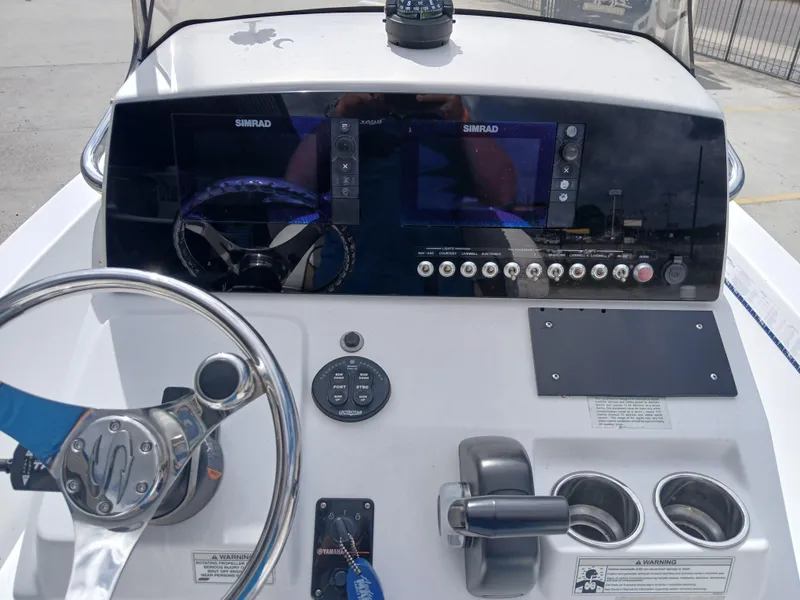 Slide: The Image of 2015 Sportsman Tournament 234 Bay Boat dashboard with steering wheel and control panel. - 7