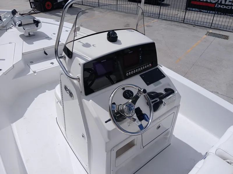 Slide: The Image of 2015 Sportsman Tournament 234 Bay Boat console with steering wheel and navigation controls. - 9