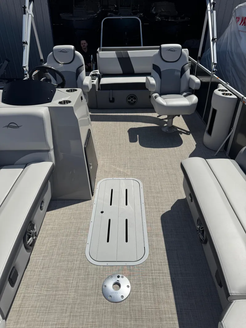 Slide: The Image of 2025 SunCatcher Select 324SL boat interior with gray seating and modern design. - 8
