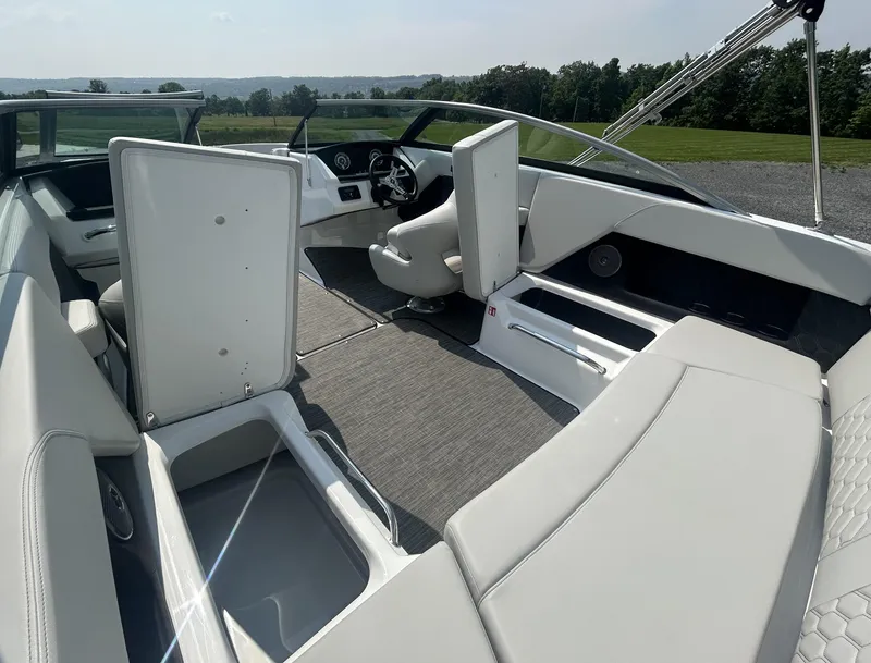 Slide: The Image of 2026 Four Winns H4 Freedom boat interior with sleek seating and modern dashboard design. - 11