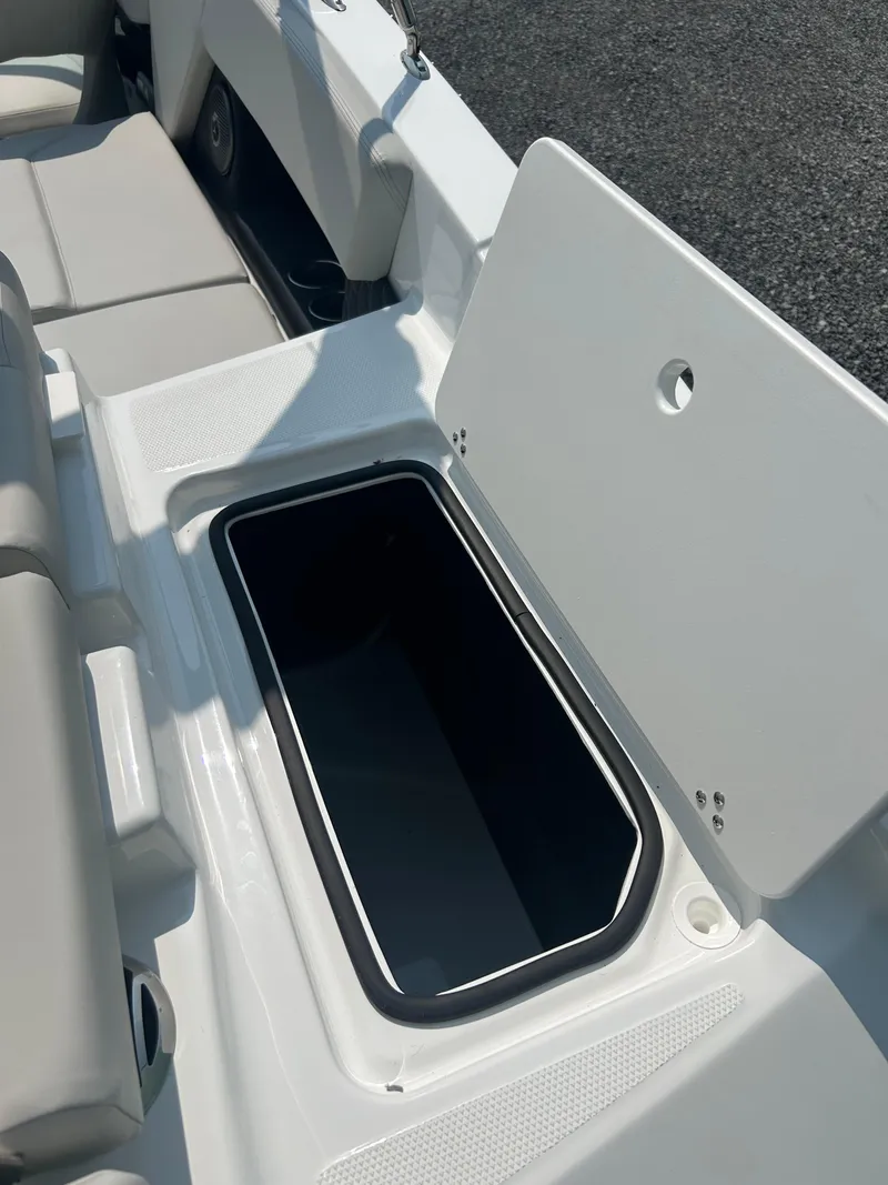 Slide: The Image of 2026 Four Winns H4 Freedom boat storage compartment with open lid, showcasing interior space. - 14
