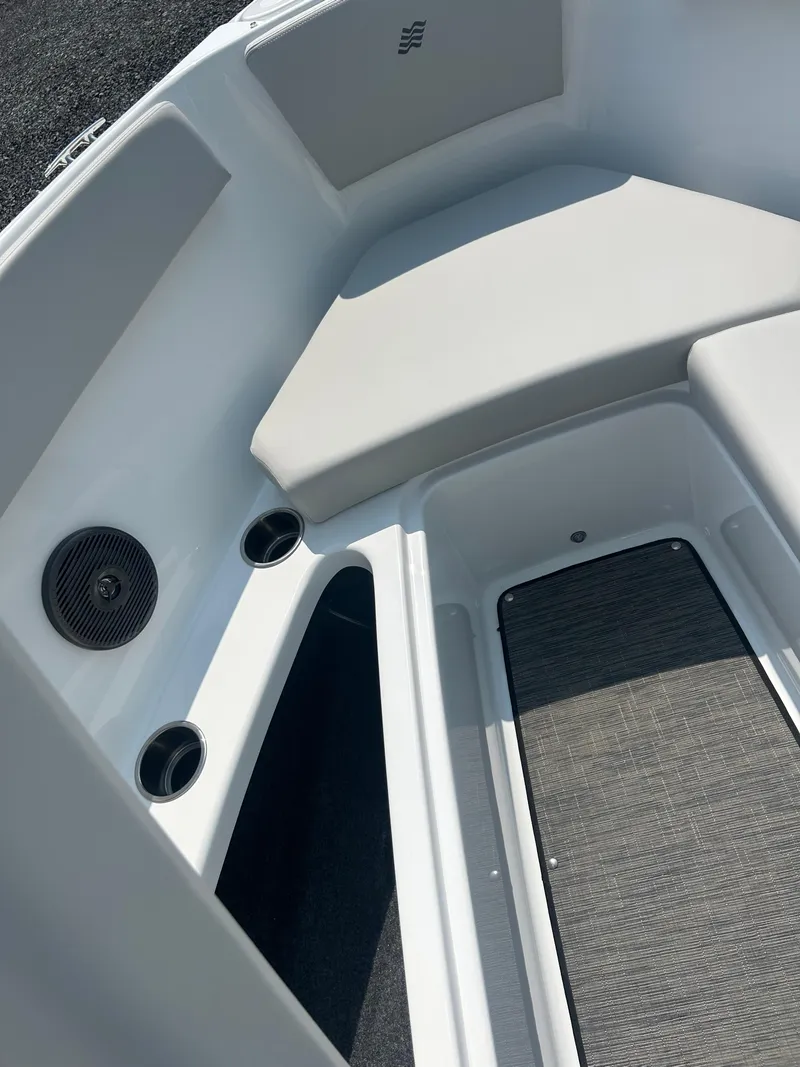 Slide: The Image of Interior of 2026 Four Winns H4 Freedom boat, featuring seating and cup holders. - 18