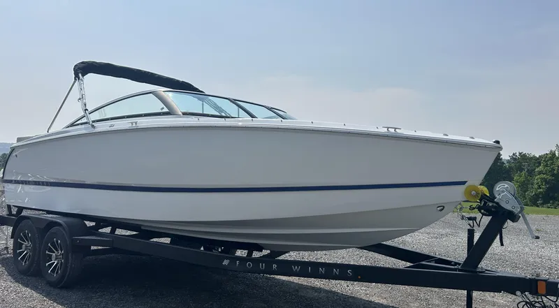 Slide: The Image of 2026 Four Winns H4 Freedom boat on trailer, sleek design, outdoors. - 4