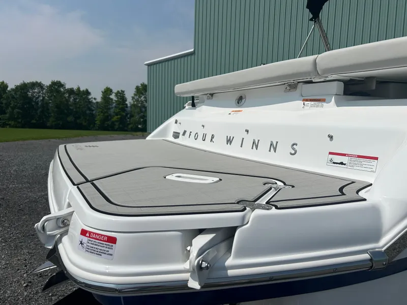 Slide: The Image of 2026 Four Winns H4 Freedom boat stern with swim platform, outdoors. - 5