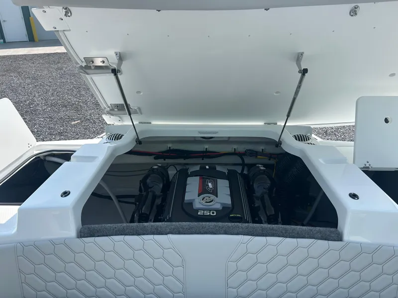 Slide: The Image of 2026 Four Winns H4 Freedom boat engine compartment with open hatch, showcasing a 250 horsepower engine. - 7