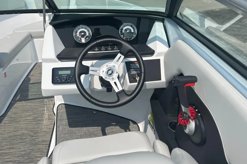 Slide: The Image of 2026 Four Winns H4 Freedom boat dashboard with steering wheel and control panel. - 9