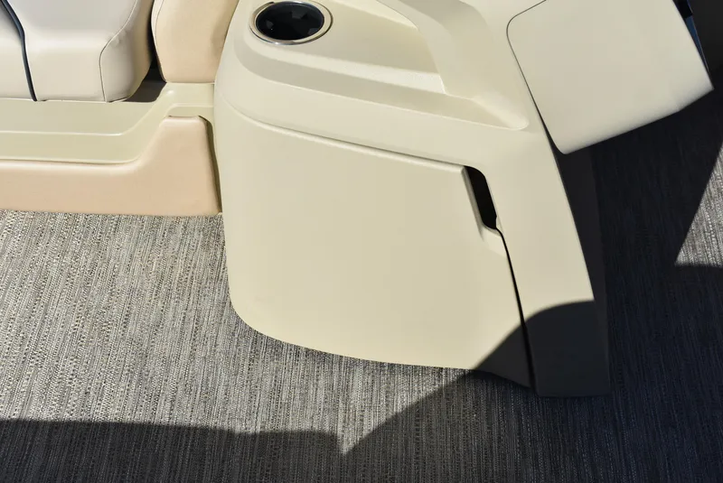 Slide: The Image of 2025 Godfrey Sweetwater 2086 SB boat interior with beige seating and cup holder. - 11