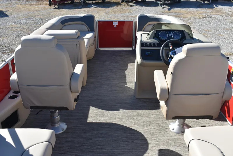 Slide: The Image of 2025 Godfrey Sweetwater 2086 SB pontoon boat interior with beige seating and steering console. - 2