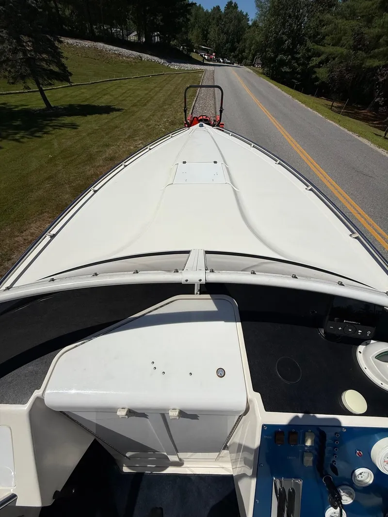 Slide: The Image of 2002 Fountain 29 Fever boat on trailer, viewed from above, parked on roadside. - 10