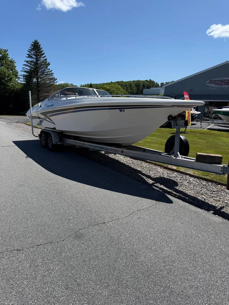 Slide: The Image of 2002 Fountain 29 Fever boat on trailer, parked outdoors under clear blue sky. - 13