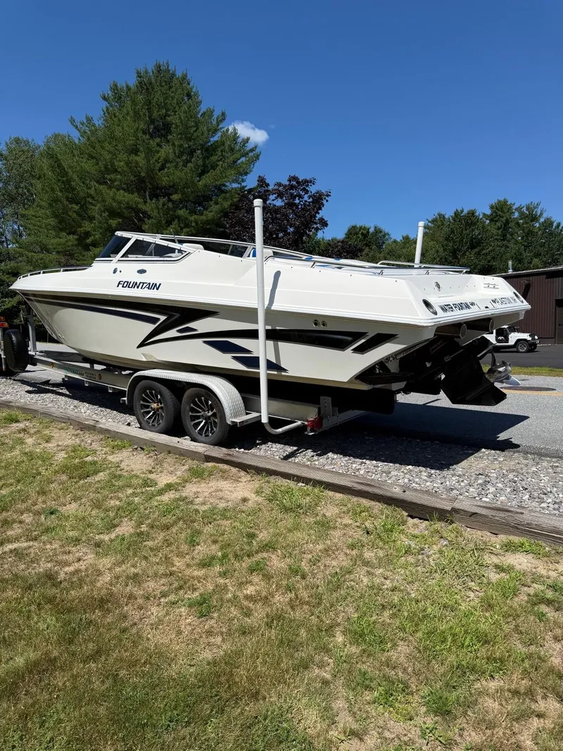 Slide: The Image of 2002 Fountain 29 Fever boat on trailer, parked outdoors on a sunny day. - 15