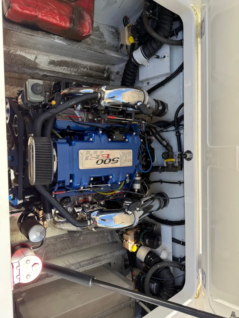 Slide: The Image of 2002 Fountain 29 Fever engine compartment with blue 500 EFI engine and red life jackets. - 5