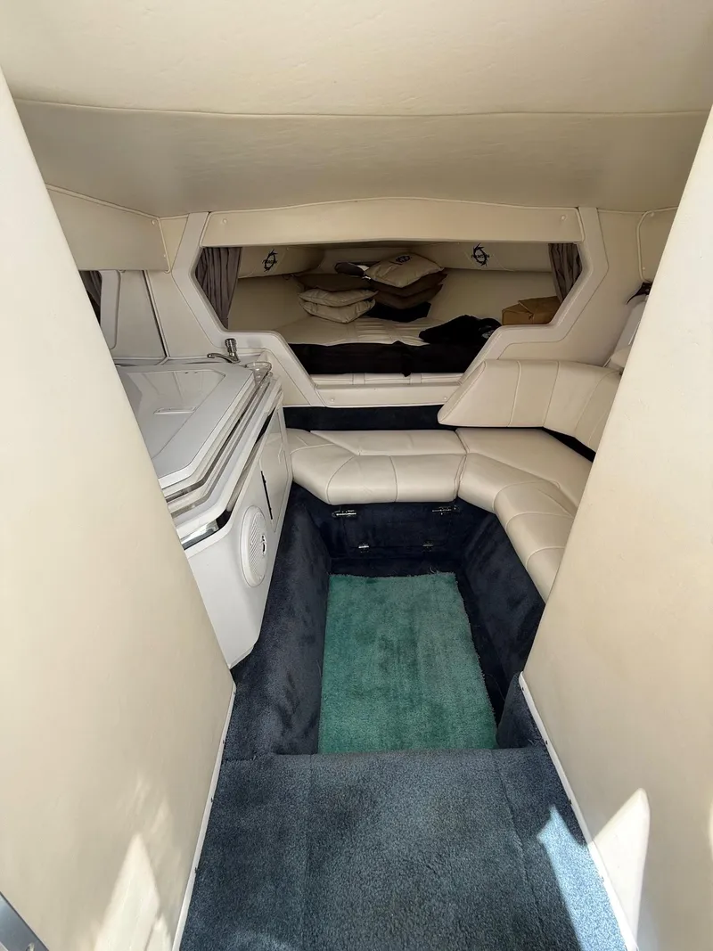 Slide: The Image of Interior of a 2002 Fountain 29 Fever boat, featuring white seating and compact design. - 9