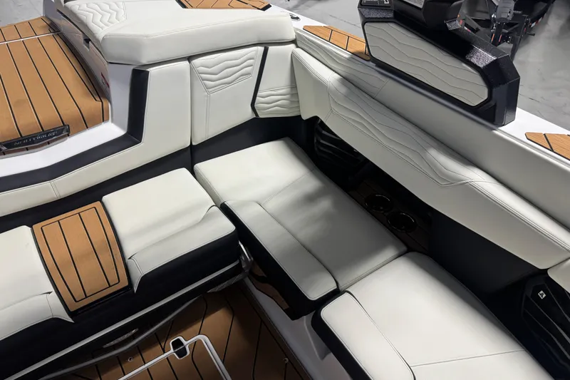 Slide: The Image of 2026 Nautique Super Air Nautique G21 interior with luxurious white and black seating. - 10
