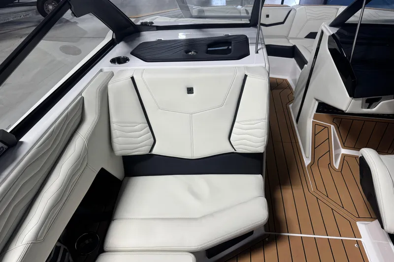 Slide: The Image of 2026 Nautique Super Air Nautique G21 interior with white leather seats and teak flooring. - 11