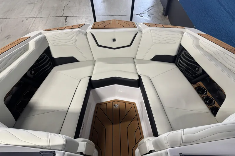 Slide: The Image of 2026 Nautique Super Air Nautique G21 interior with luxurious white seating and wood accents. - 14