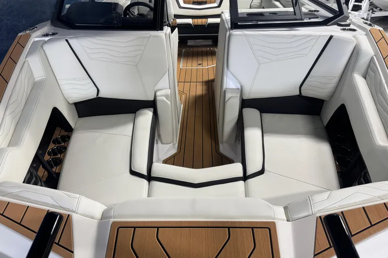 Slide: The Image of 2026 Nautique Super Air Nautique G21 interior with luxurious white seating and teak flooring. - 15