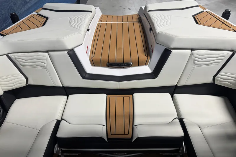 Slide: The Image of 2026 Nautique Super Air Nautique G21 interior with white and tan seating, modern design. - 7