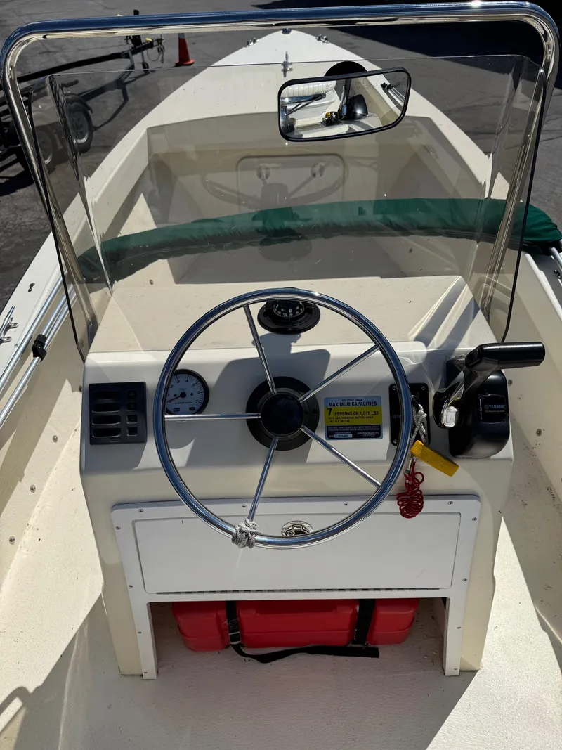 Slide: The Image of 2014 Eastern 19 boat dashboard with steering wheel and controls. - 11