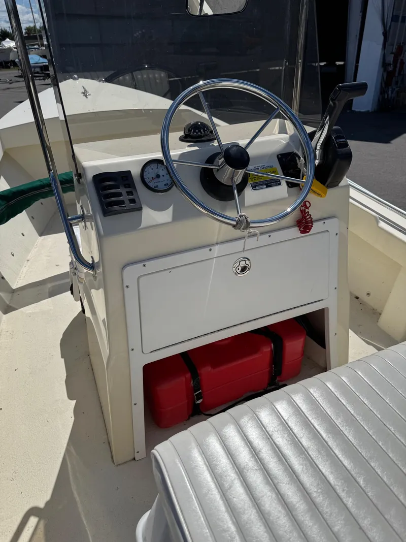 Slide: The Image of Steering console of a 2014 Eastern 19 boat with gauges and controls. - 12