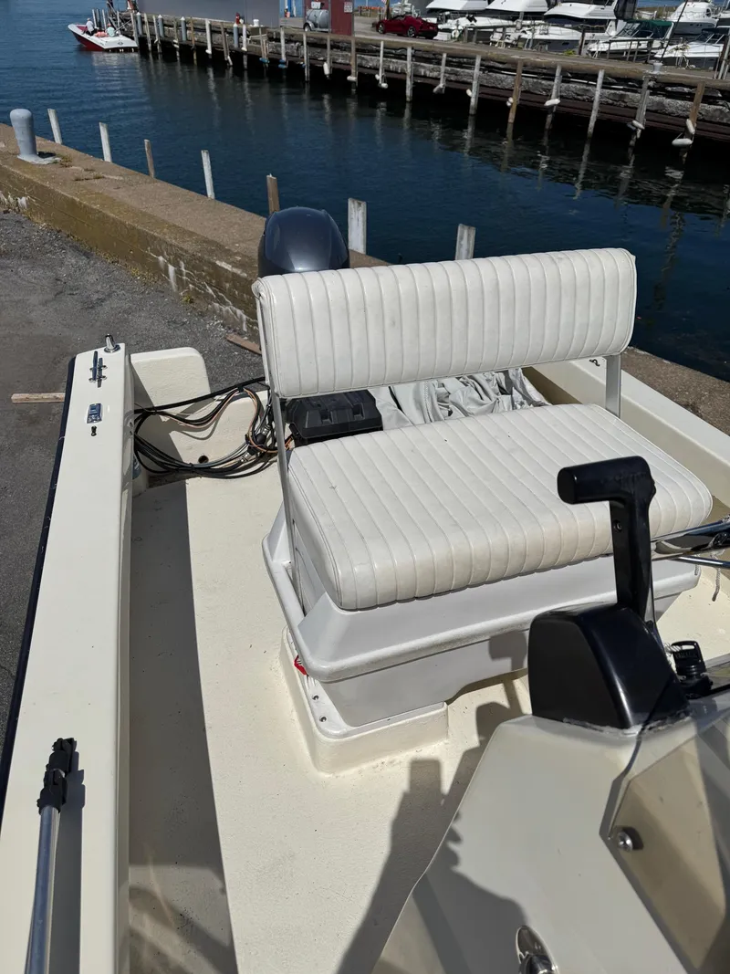 Slide: The Image of 2014 Eastern 19 boat with white seating, docked by a marina. - 14