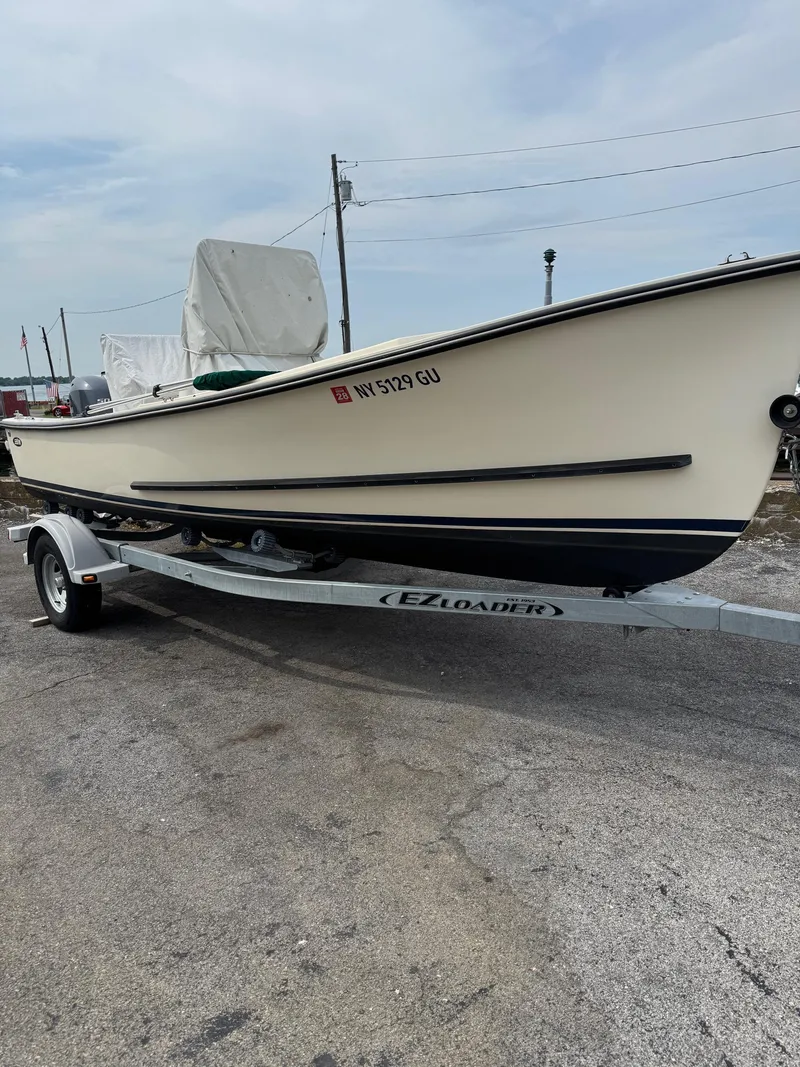 Slide: The Image of 2014 Eastern 19 boat on EZ Loader trailer, parked outdoors. - 3