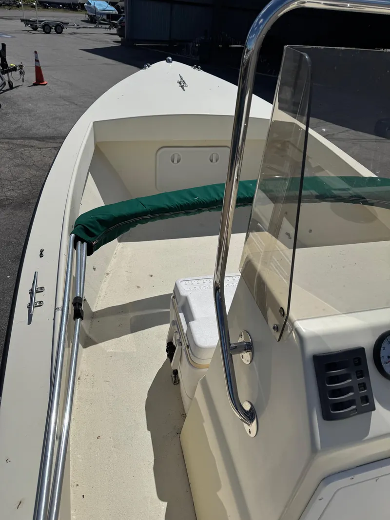 Slide: The Image of 2014 Eastern 19 boat interior with console and seating, docked outdoors. - 6