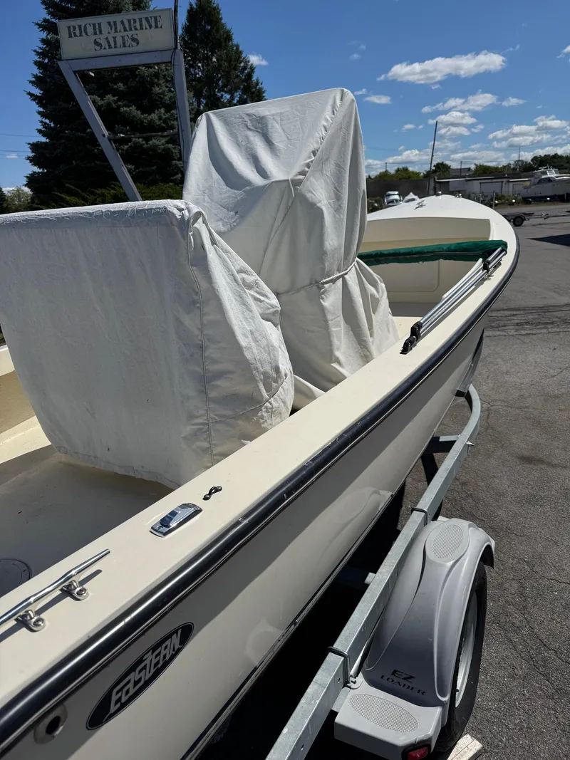 Slide: The Image of 2014 Eastern 19 boat on trailer at Rich Marine Sales, covered seats, clear sky. - 9