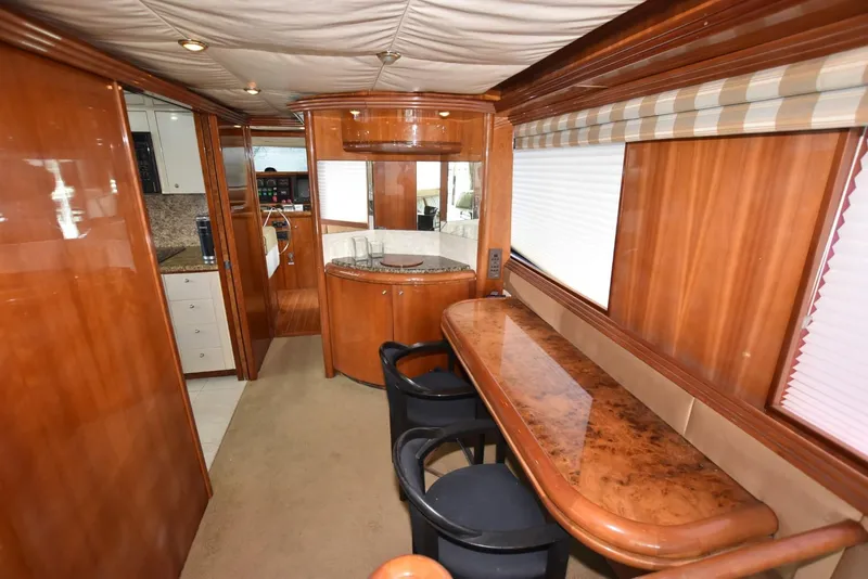 Slide: The Image of Luxurious interior of 1998 Hatteras 74 Sport Deck yacht with elegant wood finishes. - 12