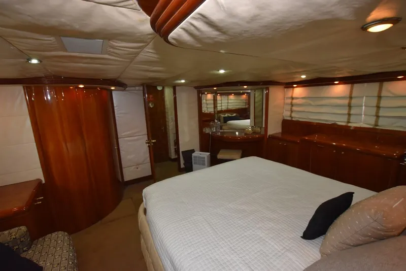 Slide: The Image of Luxurious bedroom interior of 1998 Hatteras 74 Sport Deck yacht with elegant wood finishes. - 20