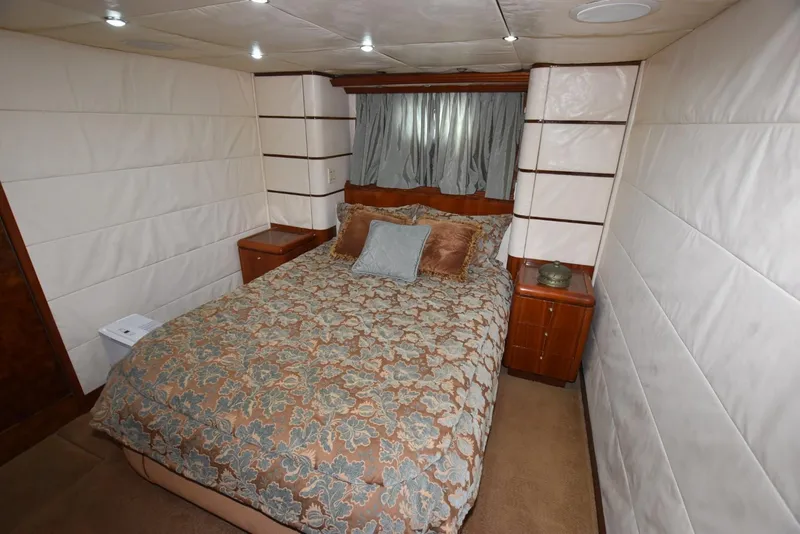 Slide: The Image of Luxurious bedroom interior of 1998 Hatteras 74 Sport Deck yacht with elegant bedding. - 24