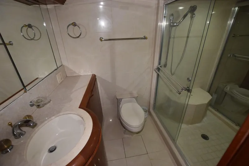 Slide: The Image of Luxurious bathroom on 1998 Hatteras 74 Sport Deck yacht with shower and vanity. - 26