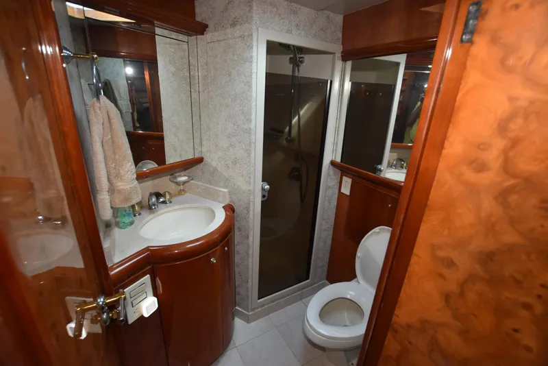 Slide: The Image of Luxurious bathroom on 1998 Hatteras 74 Sport Deck yacht with shower and wooden cabinetry. - 28