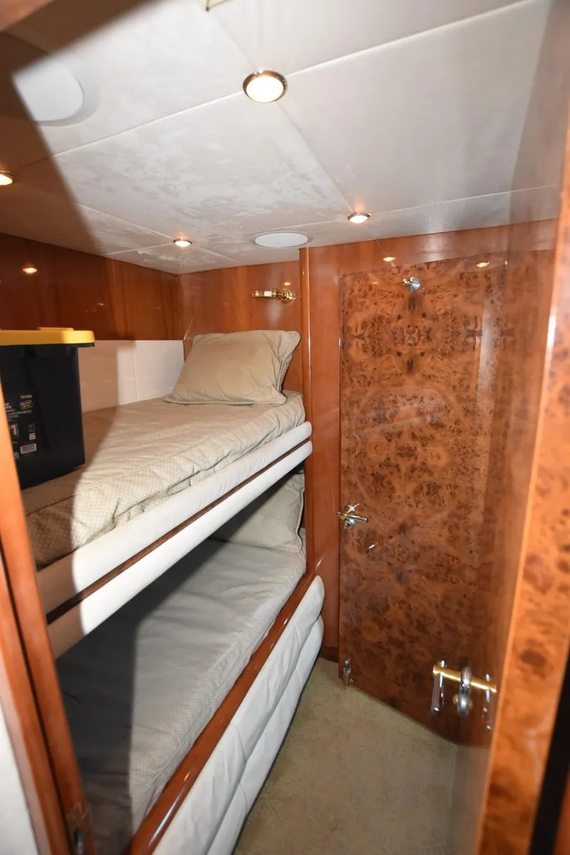 Slide: The Image of Bunk beds in 1998 Hatteras 74 Sport Deck yacht cabin with wood paneling. - 29