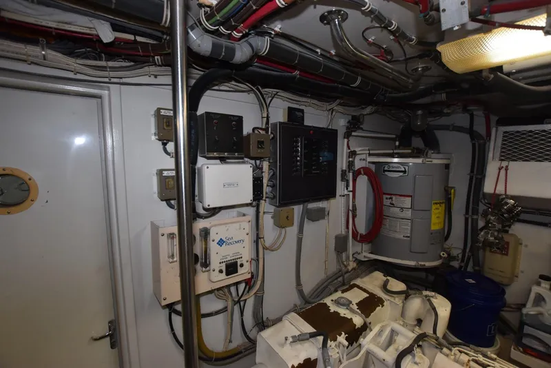 Slide: The Image of Engine room of 1998 Hatteras 74 Sport Deck yacht with equipment and wiring. - 35